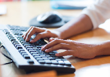 Tax preparer typing on keyboard