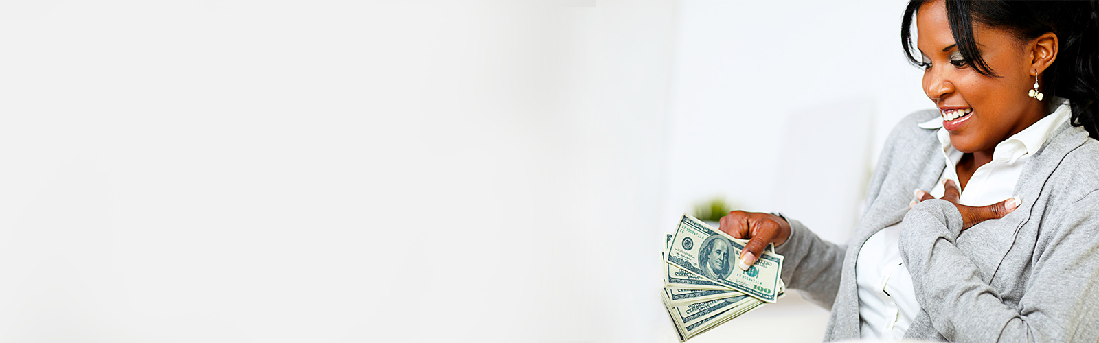 Banner of woman holding the cash from her income return.